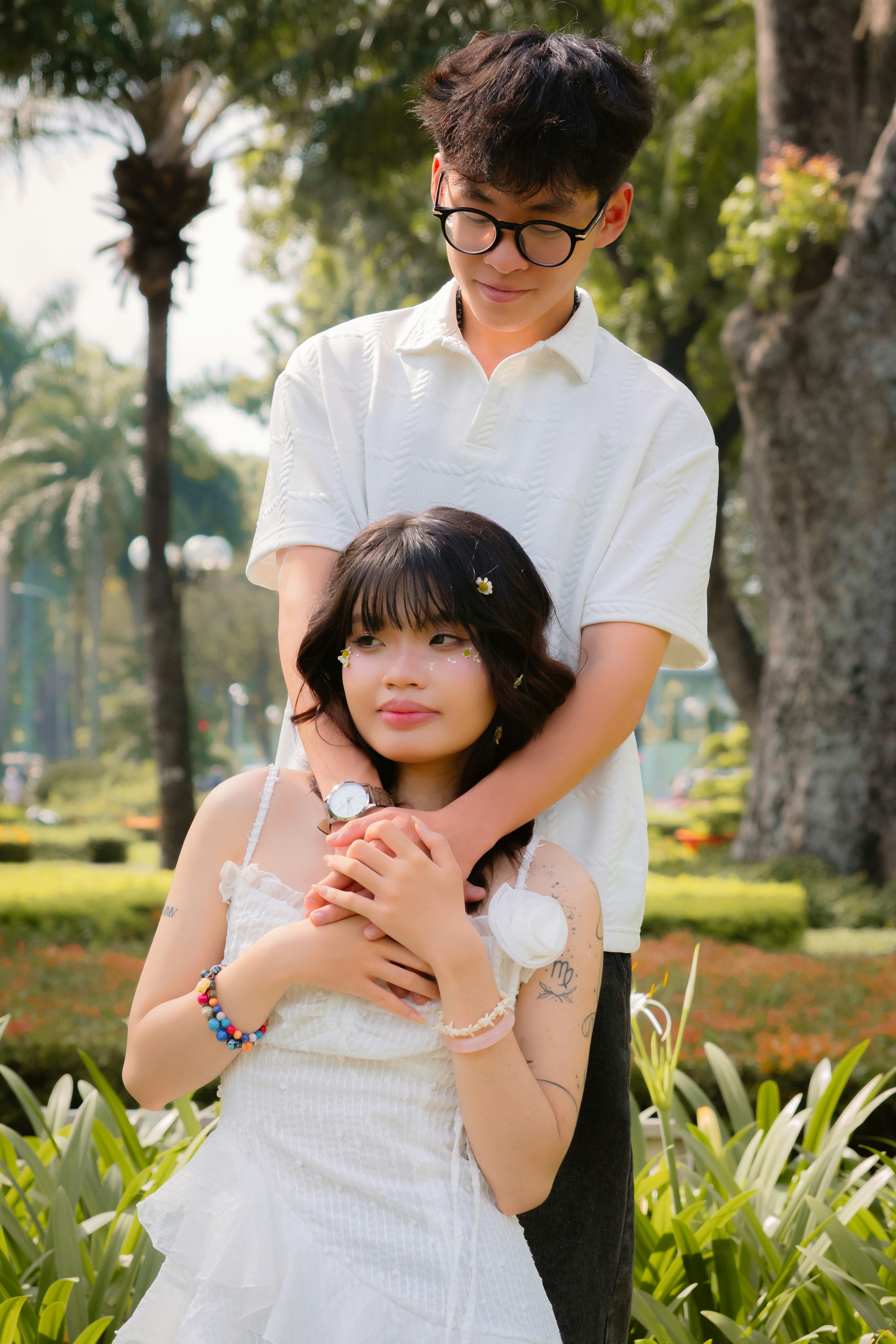 Young couple embracing in a sunny park